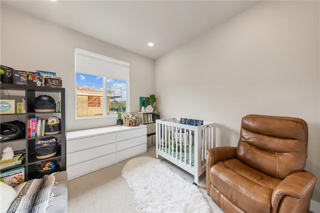 a bedroom with furniture and a book shelf