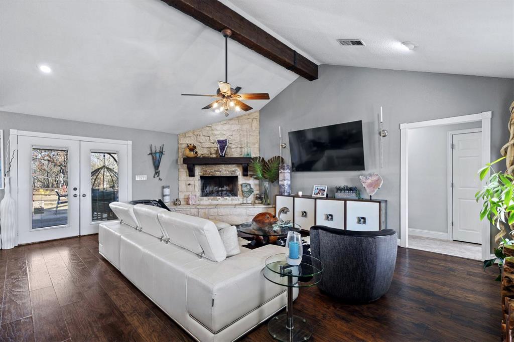 2590 Blackjack Road West Aubrey, TX 76227 - Photo 15 of 26 a living room with furniture a flat screen tv and a fireplace