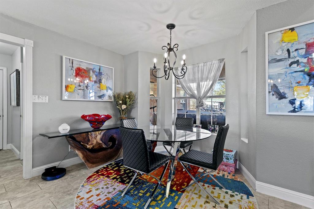 2590 Blackjack Road West Aubrey, TX 76227 - Photo 19 of 26 a view of a dining room with furniture and a chandelier