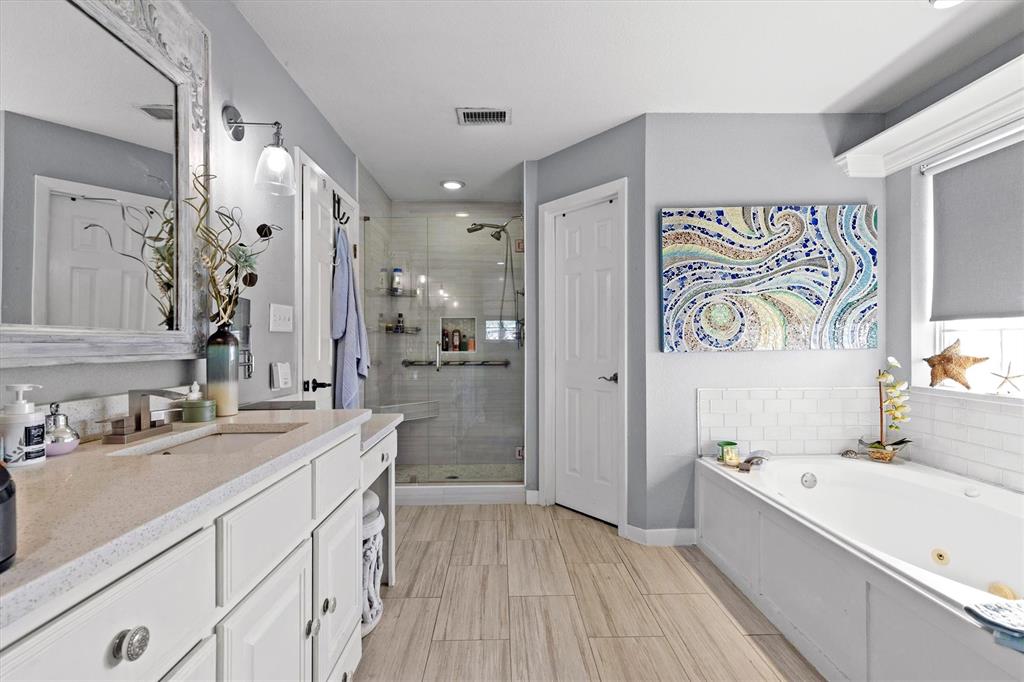 2590 Blackjack Road West Aubrey, TX 76227 - Photo 21 of 26 a bathroom with a granite countertop double vanity sink a mirror a bathtub and shower