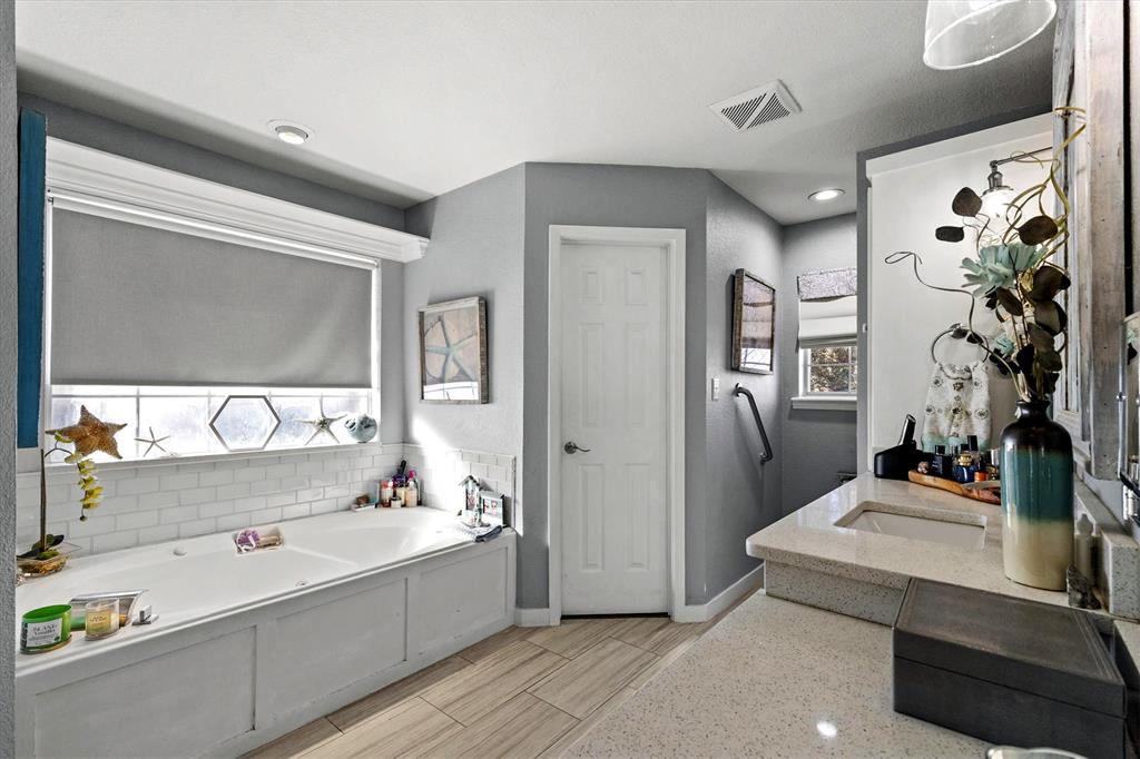 2590 Blackjack Road West Aubrey, TX 76227 - Photo 22 of 26 a bathroom with a tub sink and mirror
