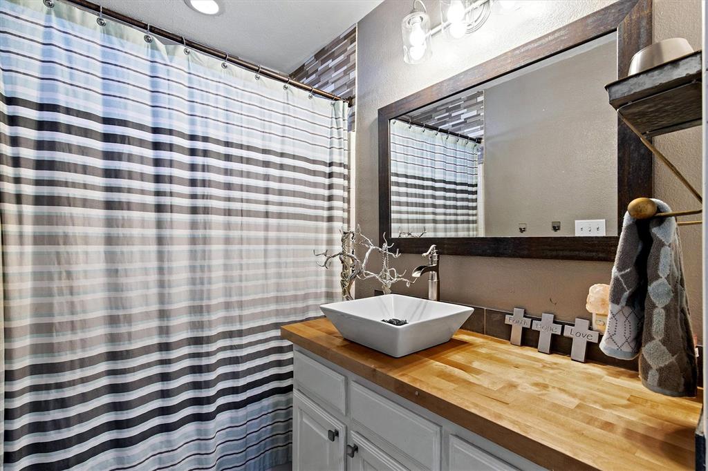 2590 Blackjack Road West Aubrey, TX 76227 - Photo 24 of 26 a bathroom with a sink and a mirror