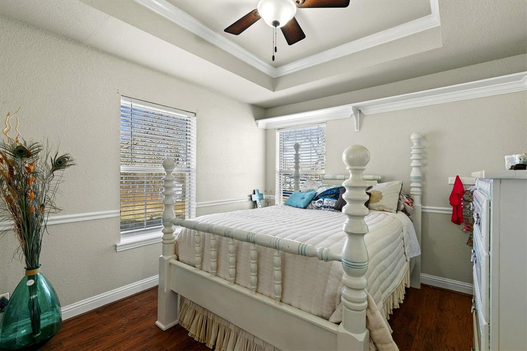 2590 Blackjack Road West Aubrey, TX 76227 - Photo 25 of 26 a bedroom with a bed and wooden floor