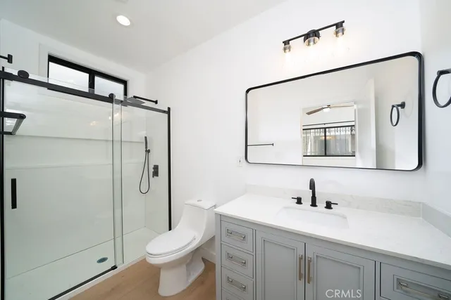 a bathroom with a toilet sink and shower