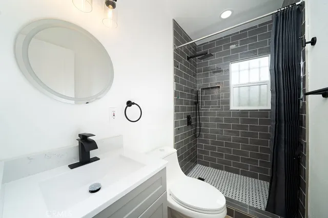 a bathroom with a sink toilet and shower