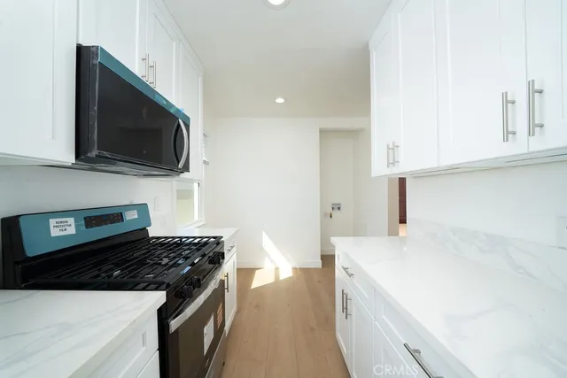 a kitchen with a sink and a stove top oven