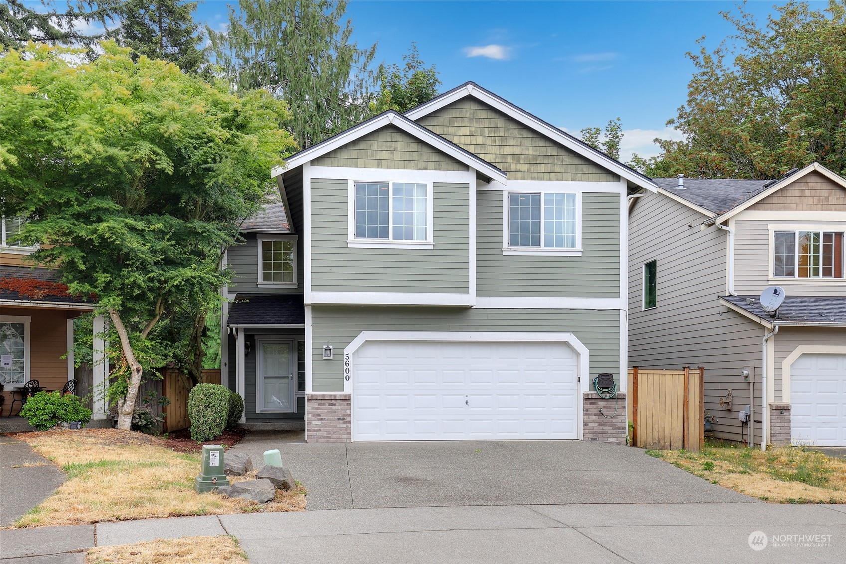 a front view of a house with a yard and garage