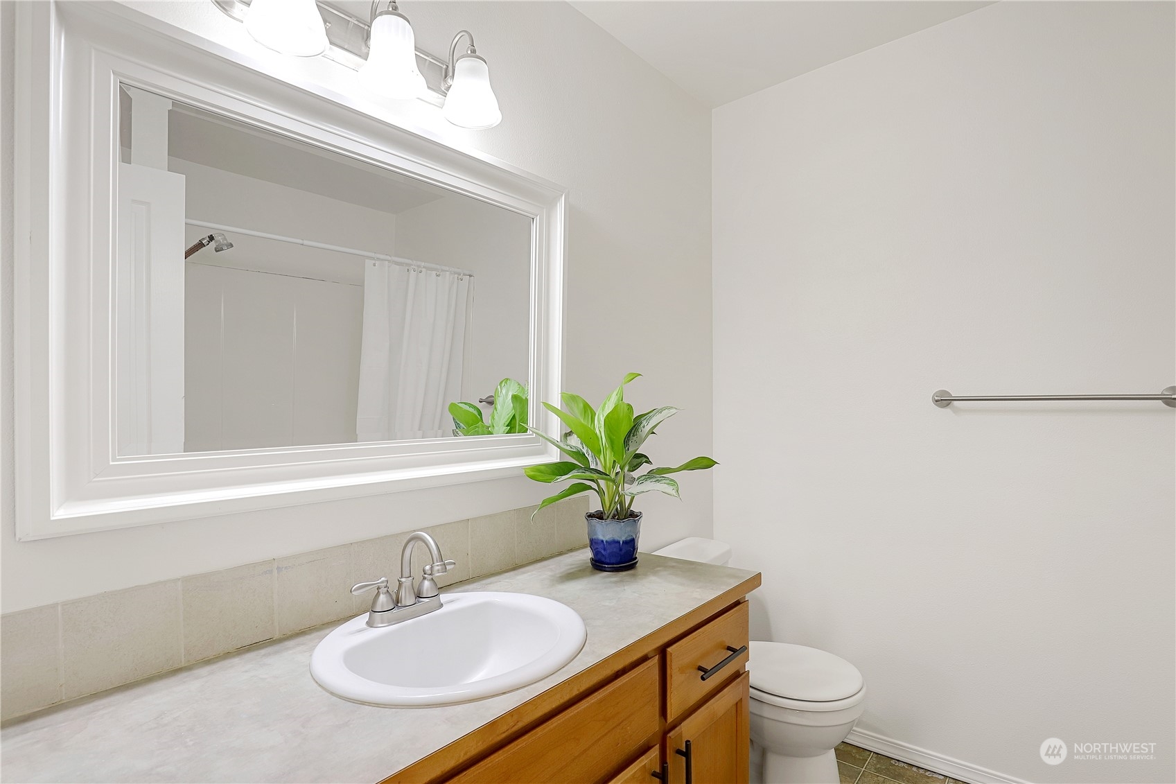 5600 55th Loop Southeast Olympia, WA 98513 - Photo 12 of 33 a bathroom with a granite countertop sink a toilet and a mirror