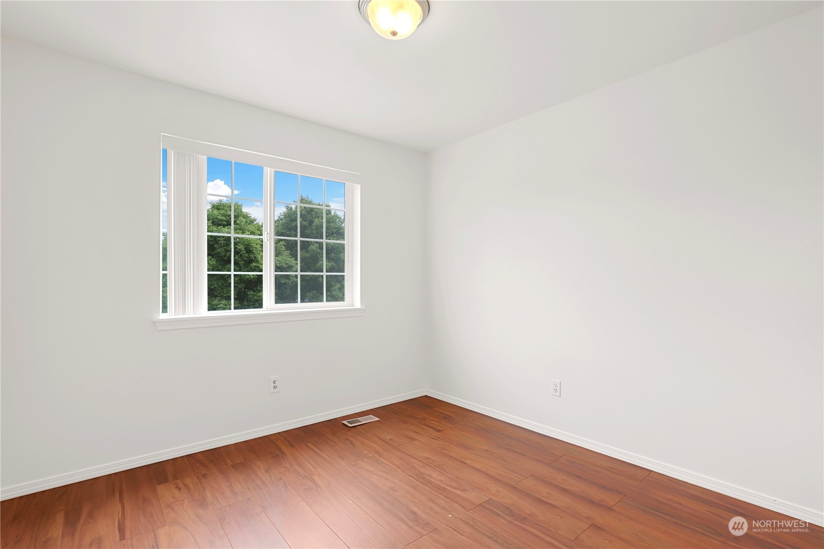 5600 55th Loop Southeast Olympia, WA 98513 - Photo 17 of 33 a view of an empty room with wooden floor and a window
