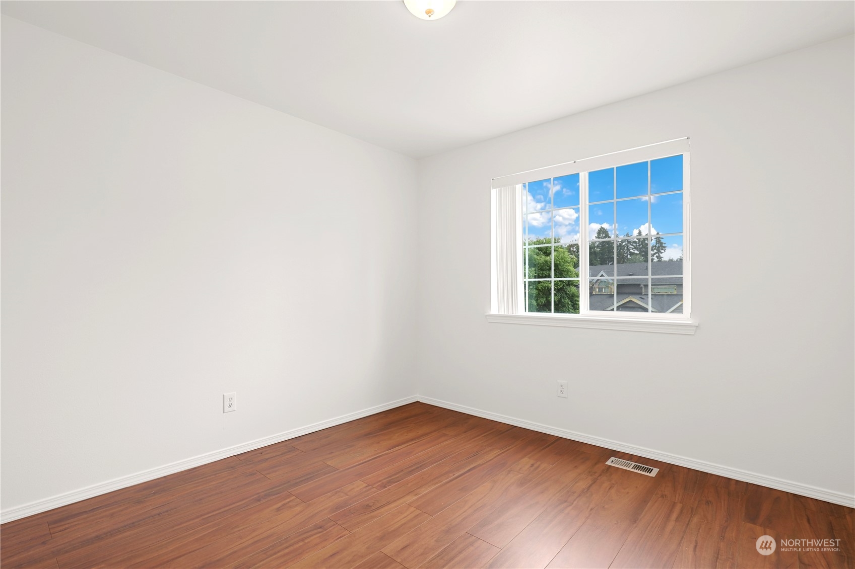5600 55th Loop Southeast Olympia, WA 98513 - Photo 20 of 33 a view of an empty room with wooden floor and a window