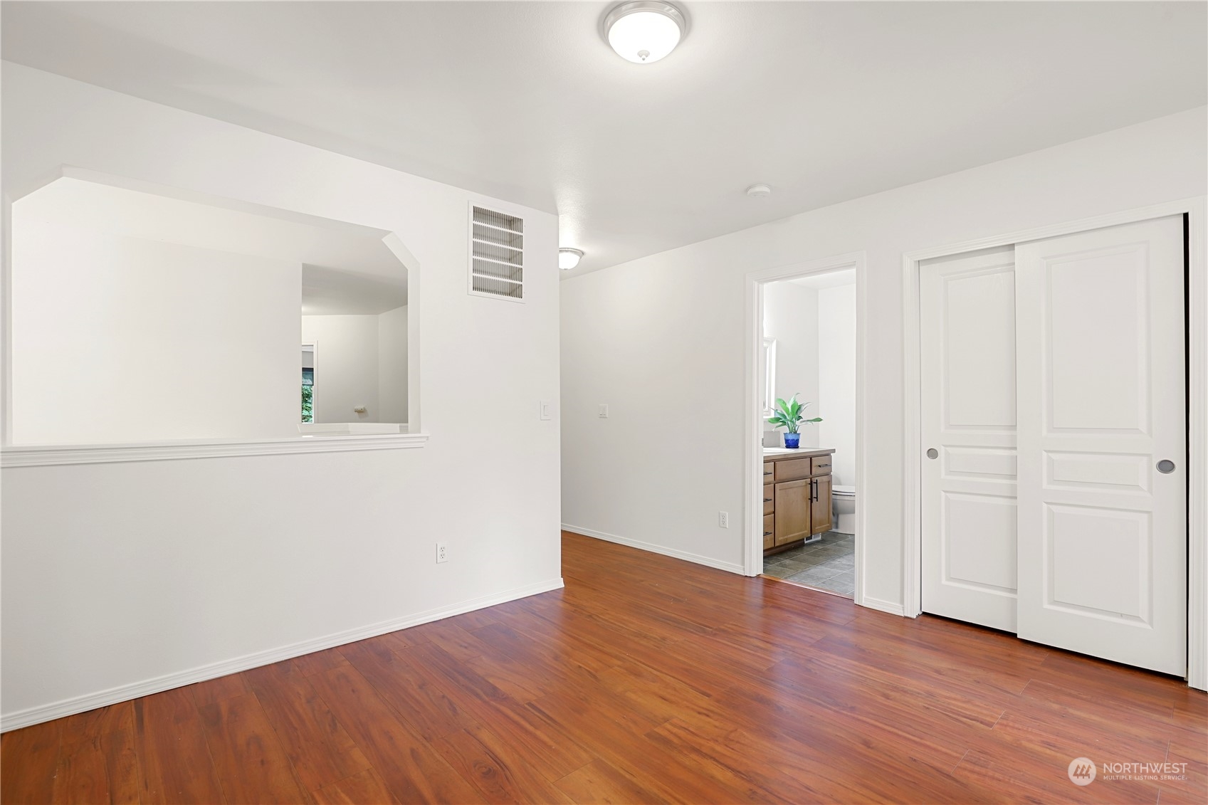 5600 55th Loop Southeast Olympia, WA 98513 - Photo 23 of 33 an empty room with wooden floor and bathroom