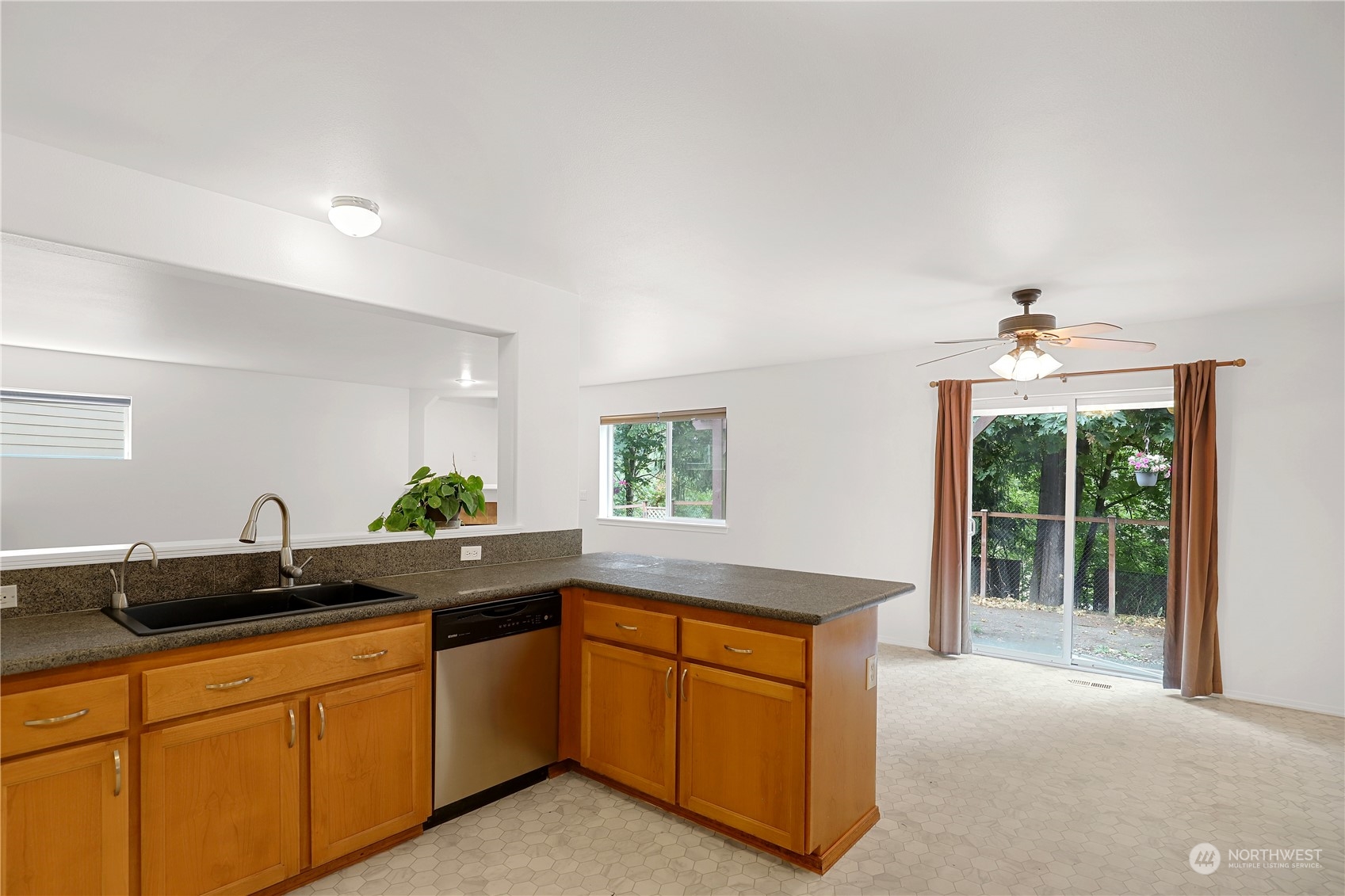 5600 55th Loop Southeast Olympia, WA 98513 - Photo 7 of 33 a kitchen with stainless steel appliances granite countertop a sink and a granite counter tops with large windows
