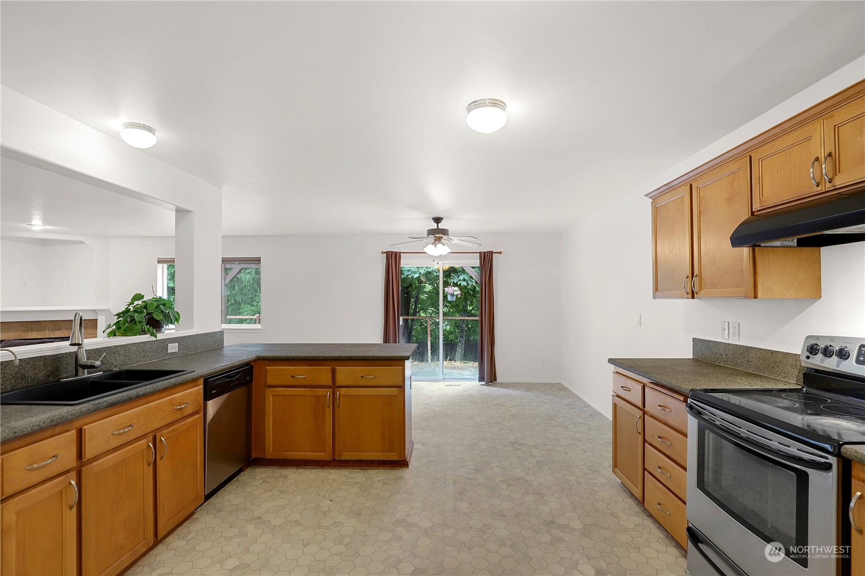 5600 55th Loop Southeast Olympia, WA 98513 - Photo 9 of 33 a kitchen with stainless steel appliances granite countertop a sink a stove and a refrigerator