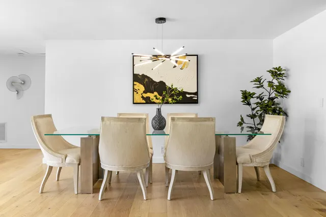 a view of a dining room with furniture and a potted plant