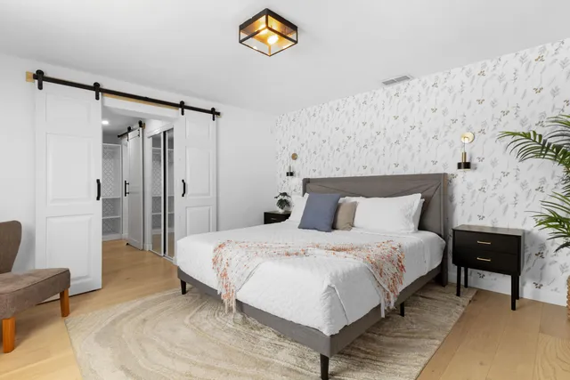 a bedroom with a bed and a couch