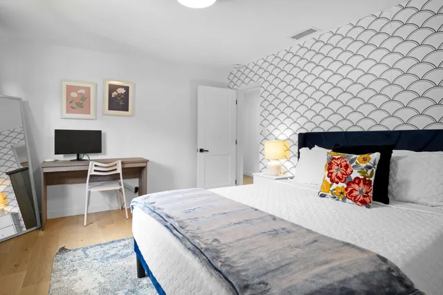 a bedroom with a bed and a flat screen tv