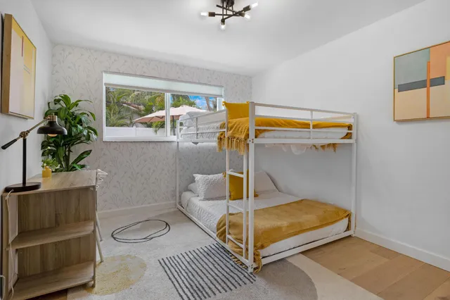 a bedroom with a bed and a potted plant