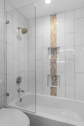 a bathroom with a shower and a tub