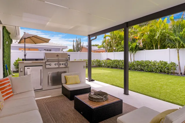 a living room with a floor to ceiling window next to a yard