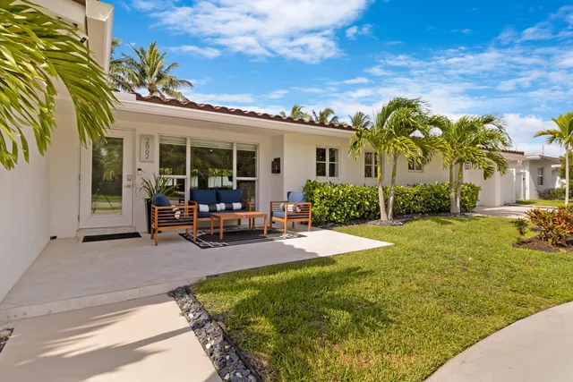 a view of a house with backyard porch and sitting area