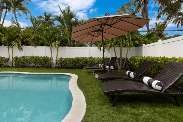 a view of a swimming pool and lounge chair