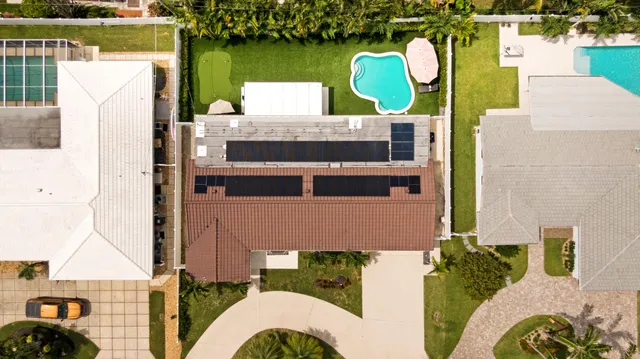 aerial view of a house with outdoor space and lake view