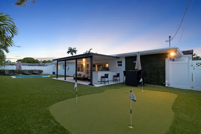 a view of a house with a porch and furniture