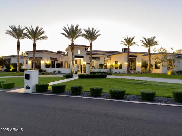 a front view of multiple houses with yard