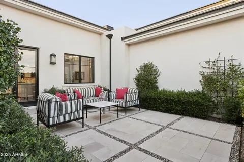 a living room with furniture and a floor to ceiling window