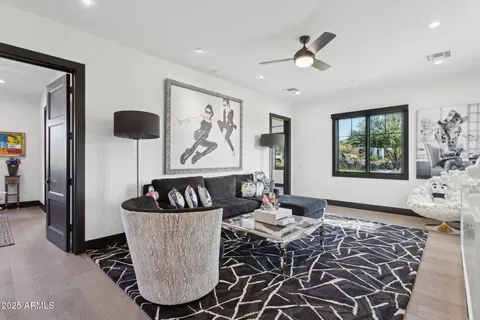 a living room with furniture and a book shelf