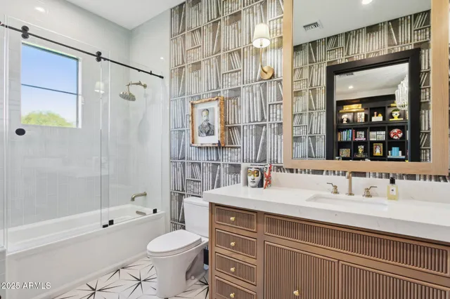 a living room with furniture a bookshelf and a book shelf