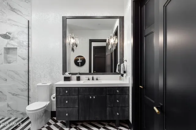 a bathroom with a sink toilet and shower