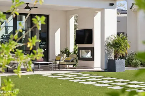a view of a swimming pool with chairs and a table