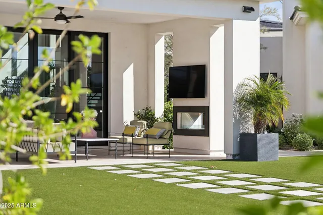 a view of a swimming pool with chairs and a table