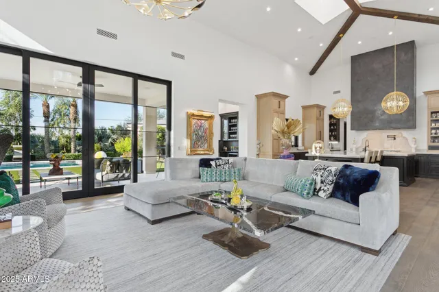 a living room with furniture and large windows