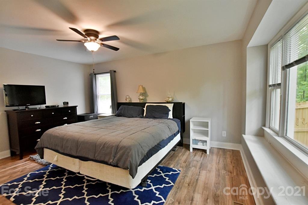 8108 Barncliff Road Charlotte, NC 28227 - Photo 14 of 25 a bedroom with a bed and wooden floor