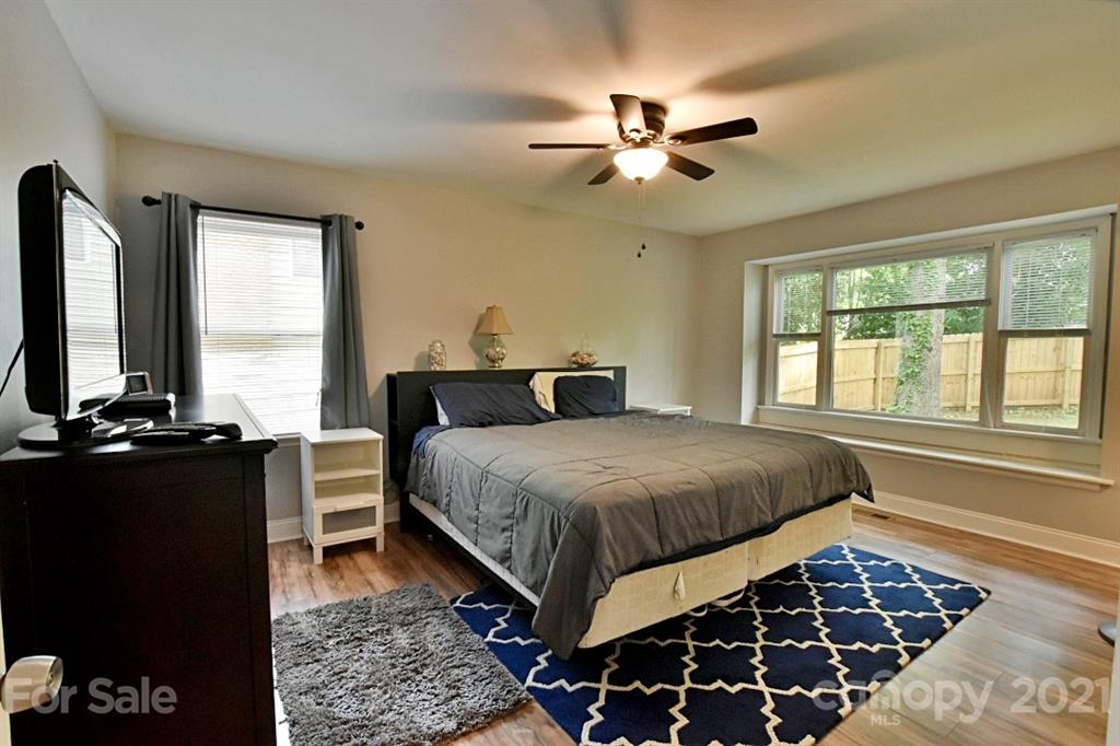 8108 Barncliff Road Charlotte, NC 28227 - Photo 15 of 25 a bedroom with a bed and a chandelier