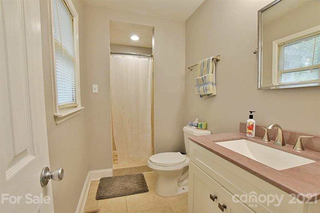 8108 Barncliff Road Charlotte, NC 28227 - Photo 16 of 25 a bathroom with a toilet a sink and mirror