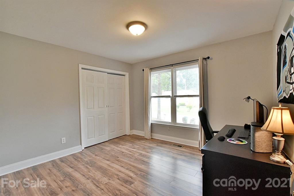 8108 Barncliff Road Charlotte, NC 28227 - Photo 17 of 25 a view of a workspace with furniture and a window