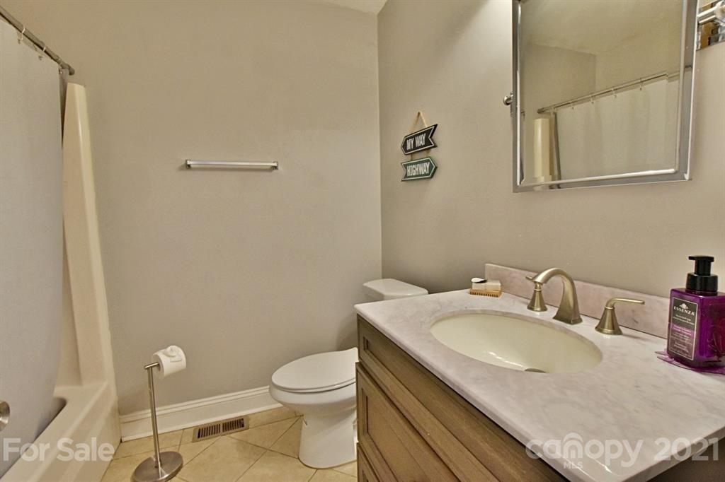 8108 Barncliff Road Charlotte, NC 28227 - Photo 19 of 25 a bathroom with a granite countertop sink toilet and mirror