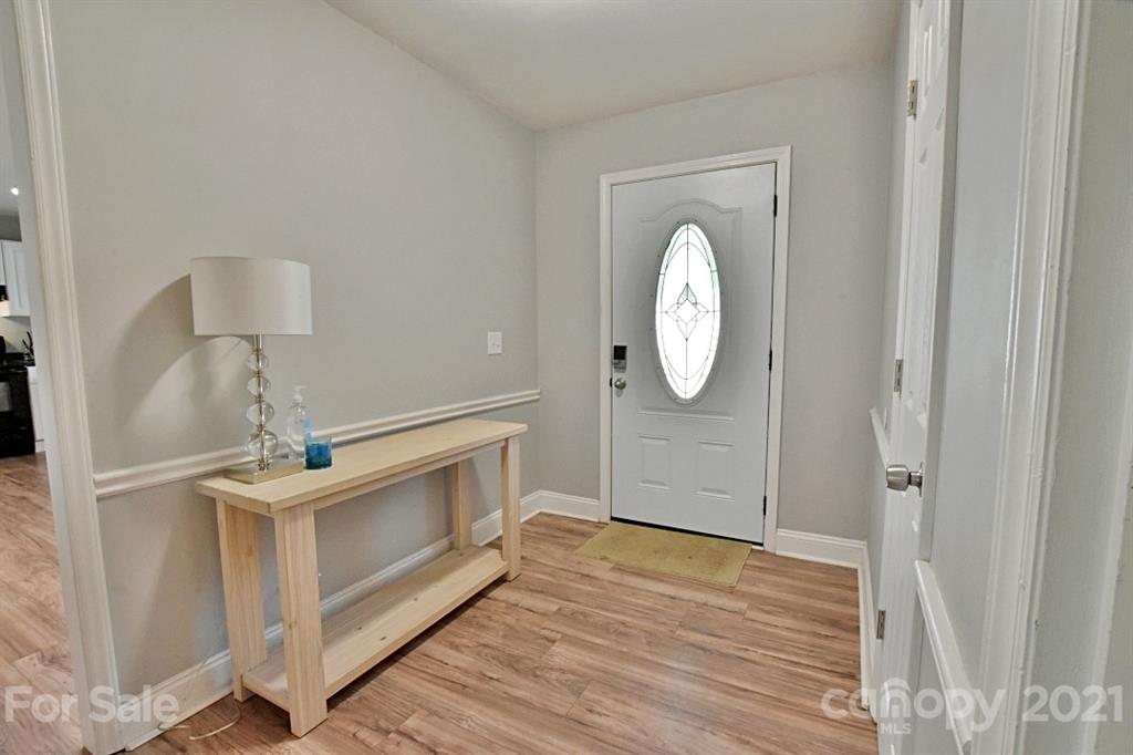 8108 Barncliff Road Charlotte, NC 28227 - Photo 4 of 25 a view of a livingroom with wooden floor and a large window