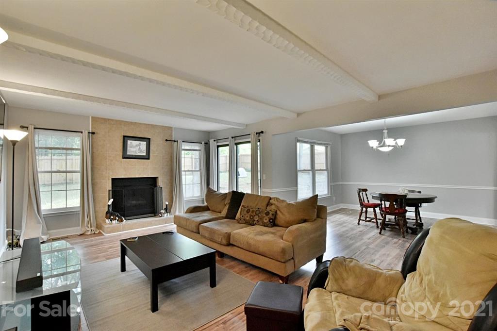 8108 Barncliff Road Charlotte, NC 28227 - Photo 6 of 25 a living room with furniture flat screen tv and a fireplace