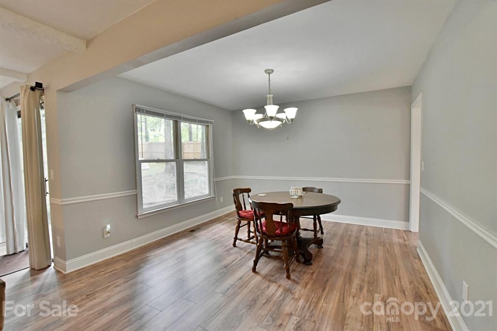 8108 Barncliff Road Charlotte, NC 28227 - Photo 7 of 25 a view of a dining room with furniture window and wooden floor