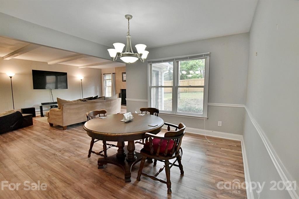 8108 Barncliff Road Charlotte, NC 28227 - Photo 8 of 25 a view of a dining room with furniture window and wooden floor