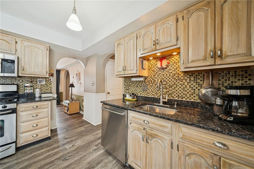 3151 Seneca Court Gibsonia, PA 15044 - Photo 2 of 38 a kitchen with stainless steel appliances granite countertop a sink a stove and cabinets
