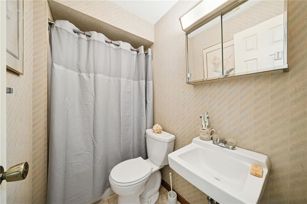 3151 Seneca Court Gibsonia, PA 15044 - Photo 25 of 38 a bathroom with a sink a toilet and shower curtain