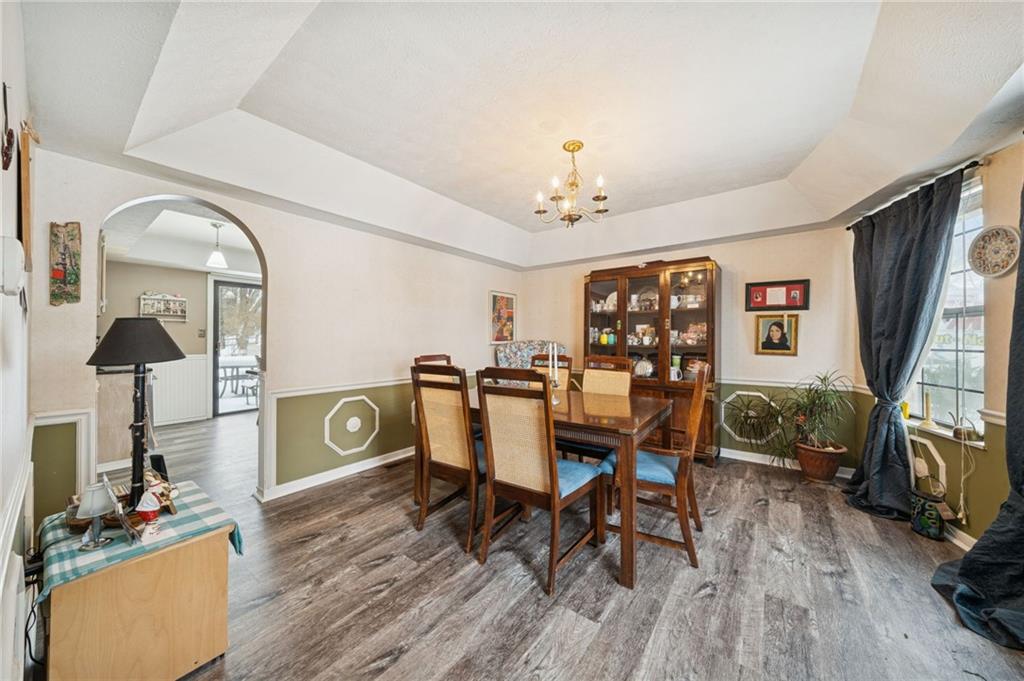 3151 Seneca Court Gibsonia, PA 15044 - Photo 7 of 38 a dining room with furniture a chandelier and wooden floor