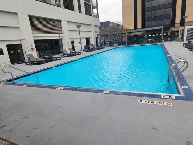 a view of a pool with a back yard