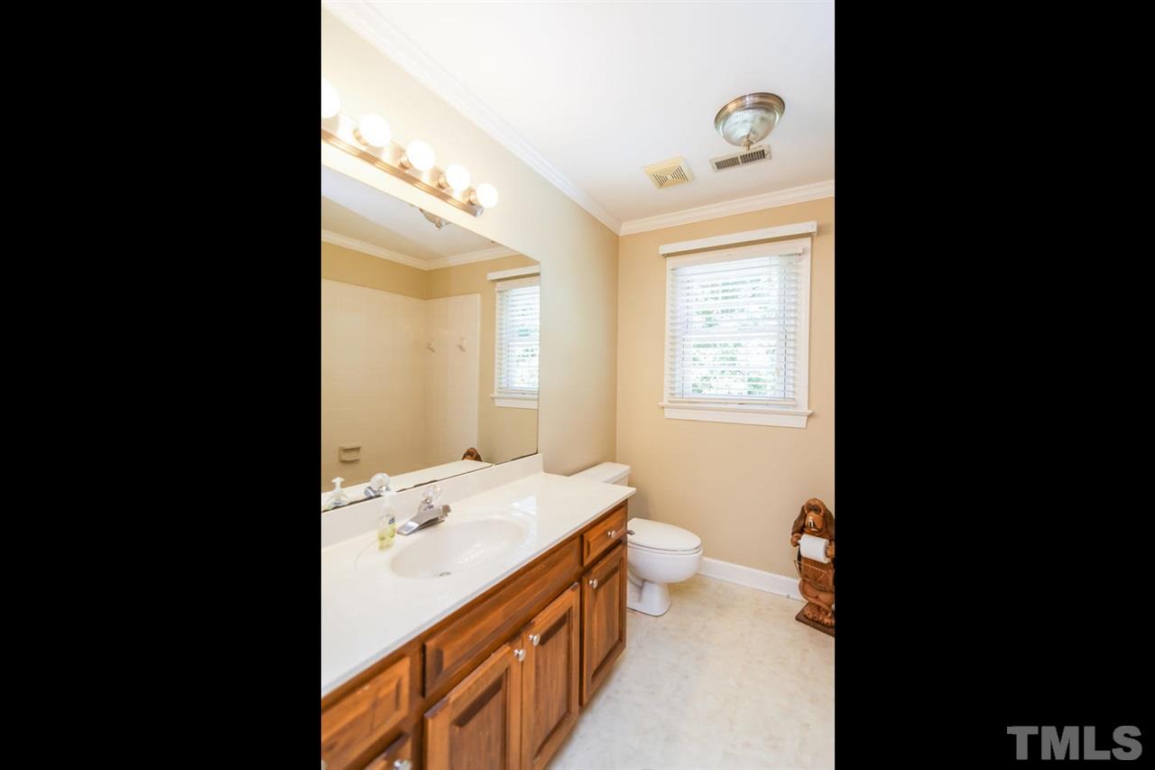 5912 Hampton Ridge Road Raleigh, NC 27603 - Photo 12 of 22 a bathroom with a double vanity sink toilet and a tub