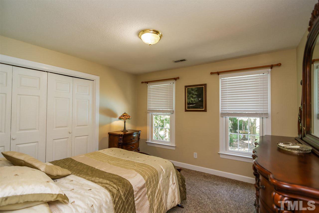5912 Hampton Ridge Road Raleigh, NC 27603 - Photo 13 of 22 a bedroom with a bed and wooden floor